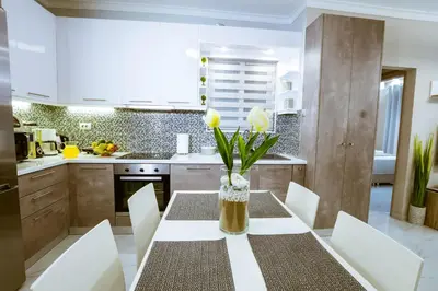 a kitchen with a table with a vase of flowers on it at Raimonda's House in Chania Town