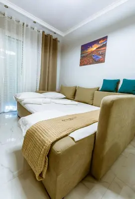 two beds and a couch in a room at Raimonda's House in Chania Town