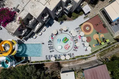 an overhead view of a swimming pool with a pool at Porto Platanias Village Resort in Plataniás