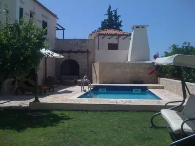 a swimming pool in the yard of a house at Douliana Villas in Douliana