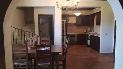 a kitchen and dining room with a table and chairs at Douliana Villas in Douliana