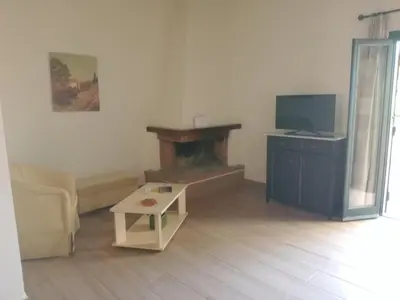 a living room with a couch and a fireplace at Douliana Villas in Douliana