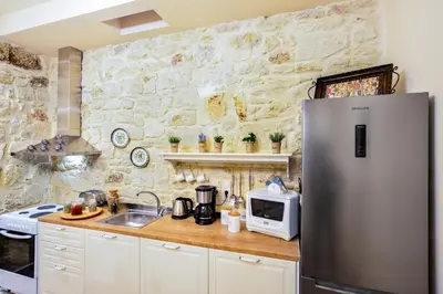 a kitchen with a refrigerator and a microwave at Michalis Stonehouse in Chania Town