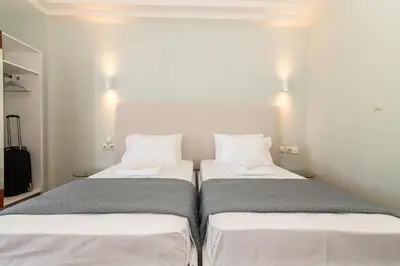 two beds sitting next to each other in a room at Girogiali beach hotel - Adults only in Stalos