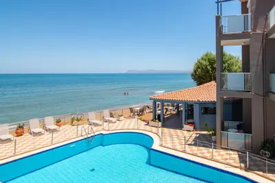 a swimming pool with a view of the ocean at Girogiali beach hotel - Adults only in Stalos