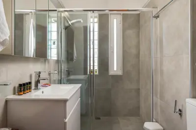 a bathroom with a shower and a sink at Villa Aphrodite in Alikianós