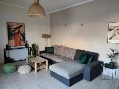 a living room with a couch and a table at Tzitzifianaki Cozy Apartment in Chania Town