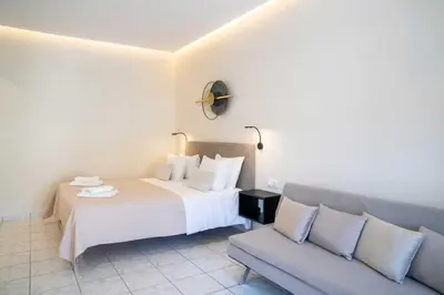 a hotel room with a bed and a couch at Avenue Hotel Falassarna in Falasarna