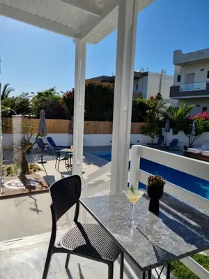 a patio with a table and chairs and a pool at Eloque Simple living space in Kato Daratso