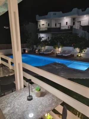 a view of a swimming pool at night at Eloque Simple living space in Kato Daratso