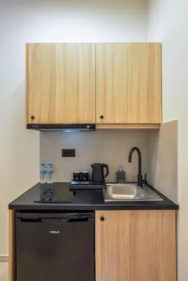 a kitchen with a sink and a black dishwasher at Eloque Simple living space in Kato Daratso