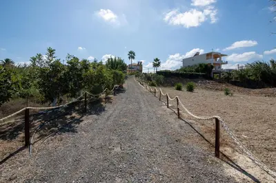 a dirt road with a fence on the side at Socrates Holidays Apt 4 with Pool near the Beach in Kamisianá