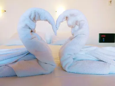 a pair of towelsrendered to look like swans at Villa Giorgos in Plataniás