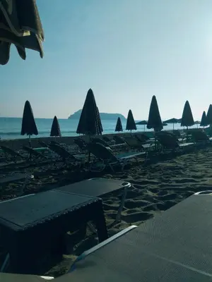a group of umbrellas and lounge chairs on a beach at Villa Giorgos in Plataniás