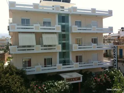 a building with white balconies on the side of it at Hotel Lefka Ori - City Rooms in Chania Town