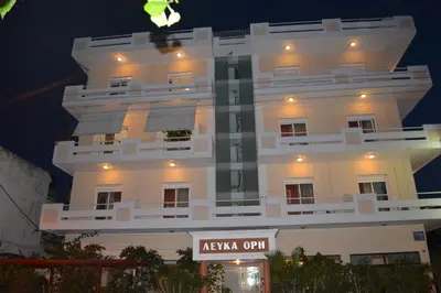 a large white building with a sign in front of it at Hotel Lefka Ori - City Rooms in Chania Town