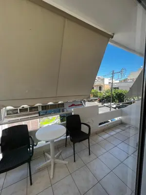 a balcony with a white table and two chairs at Hotel Lefka Ori - City Rooms in Chania Town