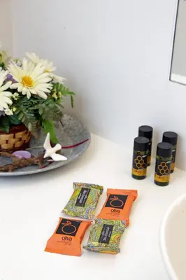 a counter with two packets of soap and a plate of flowers at Melina Apartments in Chania Town