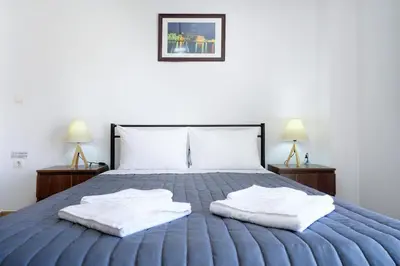 a bedroom with a bed with two towels on it at Cozy Studio Chania in Chania Town