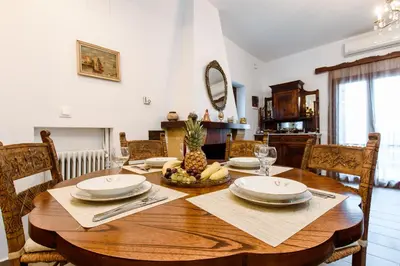 a dining room with a wooden table with a pineapple on it at Evelinas House Platanias in Plataniás