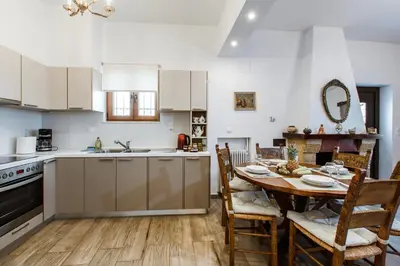 a kitchen and dining room with a table and chairs at Evelinas House Platanias in Plataniás