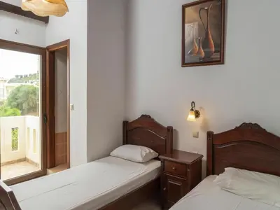 two beds in a room with a window at Modern holiday home in Stalos with balcony in Stalos