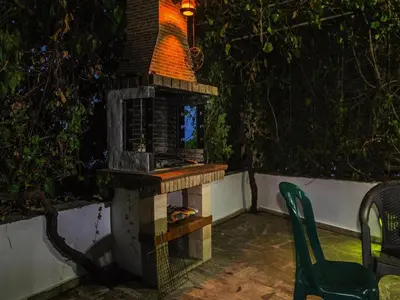 a bird house sitting on a patio at night at Modern holiday home in Stalos with balcony in Stalos