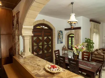 a kitchen and dining room with a table and chairs at Modern holiday home in Stalos with balcony in Stalos