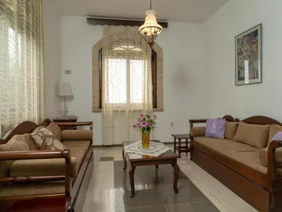 a living room with two couches and a table at Modern holiday home in Stalos with balcony in Stalos