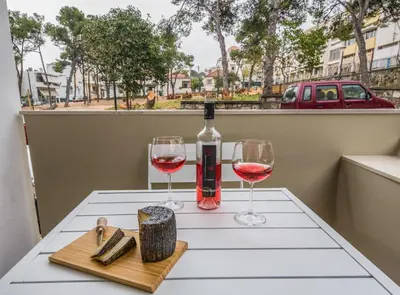 a table with two glasses and a bottle of wine at Nest of Marmel Luxury Studio in Chania Town