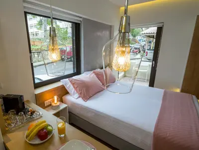 a bedroom with a bed with two lamps and a table at Nest of Marmel Luxury Studio in Chania Town