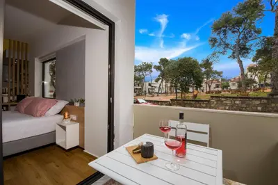 a room with a bed and a table with wine glasses at Nest of Marmel Luxury Studio in Chania Town