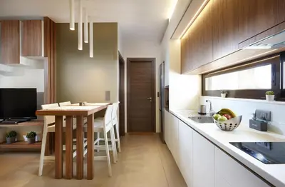 a kitchen with a table and a dining room at Armi Luxury Apartment in the Heart of the City in Chania Town