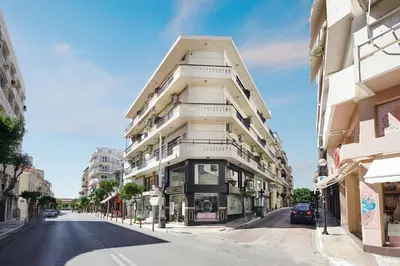 a white building on the side of a street at Armi Luxury Apartment in the Heart of the City in Chania Town