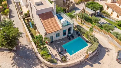 an aerial view of a house with a swimming pool at Superior Villa Kleanthi in Stalos