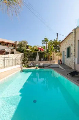 a swimming pool in a villa with blue water at Superior Villa Kleanthi in Stalos