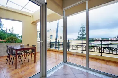 a dining room with sliding glass doors and a table at Sunny Apartment in Daratso