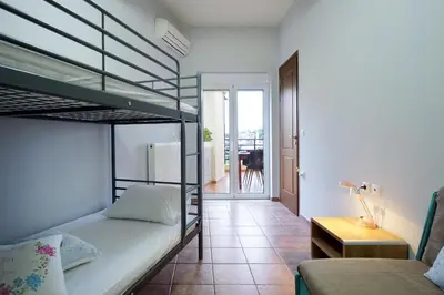 a bedroom with a bunk bed and a living room at Sunny Apartment in Daratso