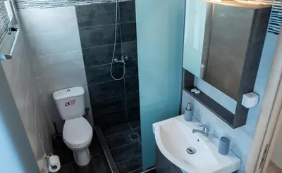 a bathroom with a toilet and a sink and a shower at Mare I - studio in Old Harbor in Chania Town