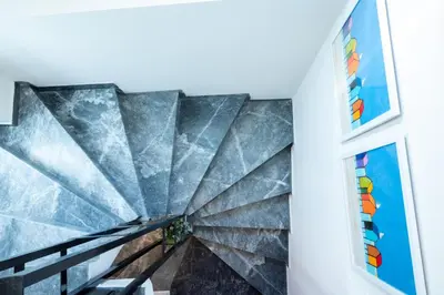a staircase in a house with a marble wall at Mare II - Studio in Old Harbor in Chania Town