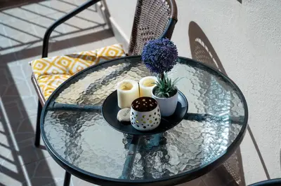 a glass table with candles and a plant on it at Mare II - Studio in Old Harbor in Chania Town