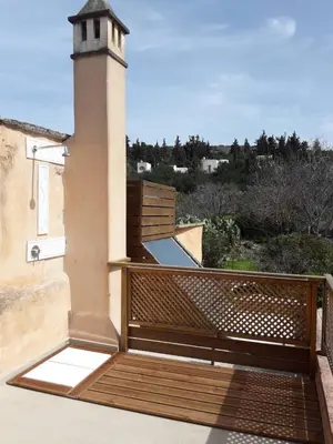 a balcony with a wooden railing and a lighthouse at Lemon Tree Eco-Retreat in Gavalochori