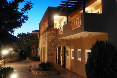 a large house at night with its lights on at Areti Aparthotel in Áptera