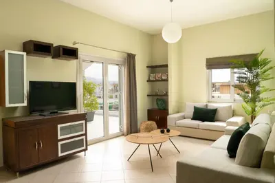 a living room with a couch and a television at Amaen Apartment in Chania Town