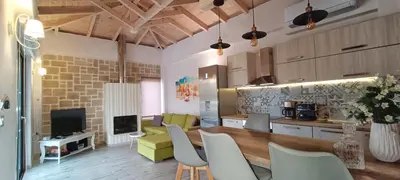 a kitchen and living room with a table and chairs at Elena Villa in Kissamos