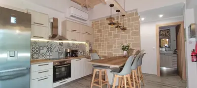 a kitchen with a table and chairs in a kitchen at Elena Villa in Kissamos