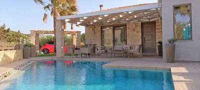 a house with a swimming pool and a pergola at Elena Villa in Kissamos