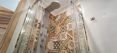a staircase with a mosaic wall in a room at Elena Villa in Kissamos