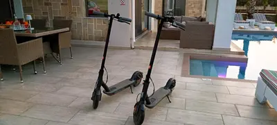 a pair of scooters parked next to a pool at Elena Villa in Kissamos
