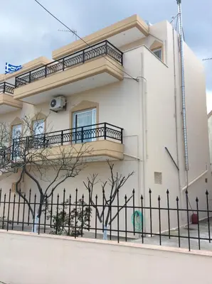 a white house with a fence in front of it at Anatoli View in Agia Marina Nea Kydonias